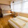 Betten im Familienzimmer large im JUFA Hotel Bregenz am Bodensee mit Fenster. Der Ort für tollen Sommerurlaub an schönen Seen für die ganze Familie.