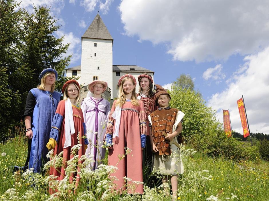 Verkleidete Teens als mittelalterliche Burgfräulein vor der Burg Mauterndorf in der Nähe vom JUFA Hotel Lungau