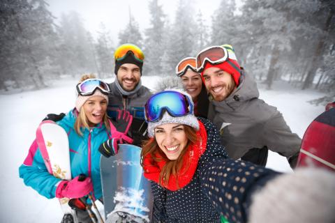 Smiling group of skiers together in mountain