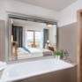 Sie sehen ein Badezimmer im JUFA Hotel Neutal – Landerlebnis mit Badewanne. JUFA Hotels bietet Ihnen den Ort für erlebnisreichen Natururlaub für die ganze Familie.