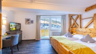 Sie sehen das Doppelzimmer plus im JUFA Alpenhotel Saalbach**** mit Balkon, TV und Wandschrank. Der Ort für erholsamen Familienurlaub und einen unvergesslichen Winter- und Wanderurlaub.