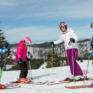 Sie sehen eine Familie beim Skifahren im Skigebiet Annaberg. JUFA Hotels bietet erholsamen Familienurlaub und einen unvergesslichen Winterurlaub.