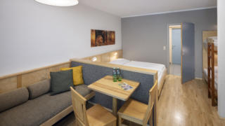 Sie sehen ein Zimmer aus der Kategorie FF4 im JUFA Hotel im Weitental / Bruck a.d. Mur. JUFA Hotels bietet erholsamen Familienurlaub und einen unvergesslichen Winter- und Wanderurlaub.